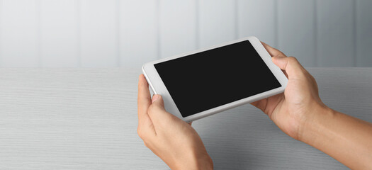 Hands holding  tablet touch computer gadget with  screen