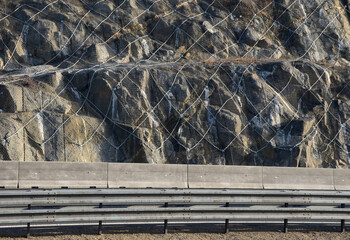 strengthening the slope with a steel net anchored deep into the rock. falling rocks do not fall on...