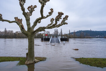 View to a jetty on the riverside path flooded by the Rhine near R&uuml;desheim / Germany