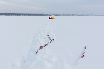 Man training with a kite on a frozen river in winter, Kama Reservoir, Perm city, Russia