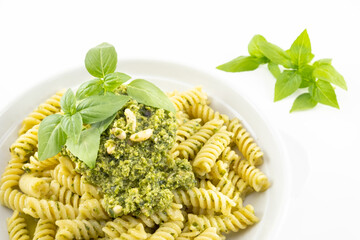 Pasta with pesto, basil leaves with white background