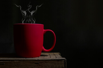 Red coffee cup with hot steam coming out making aroma in office