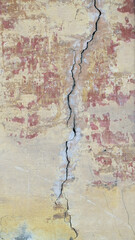 The old wall of the house. Crack. Plaster.