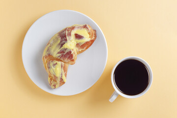 Glazed bun and coffee