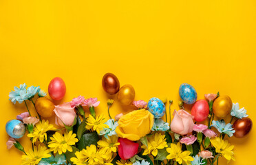 Easter background with Easter eggs and spring flowers.