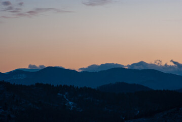 Silhouette of hills and forest at sunset