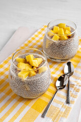 Vegan chia coconut pudding with mango on white background. Healthy nutrition, superfood. Closeup view.