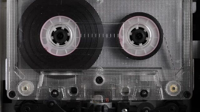 Vintage audio cassette tape playing. Rotation of rolls of film. Close up footage