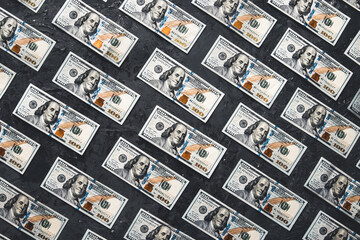 One hundred dollar bills are creatively laid out. Business concept, development perspective.