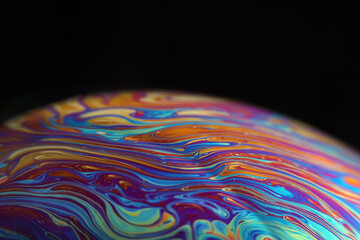 Macro picture of half soap bubble on black ground look like abstract psychedelic color planet in space	 - 410146866