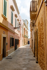 Fototapeta na wymiar Narrow street in the historic center of Ugento, Salento, Apulia, Italy - Europe