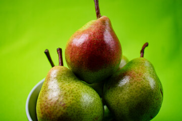bright and fresh pears on green background