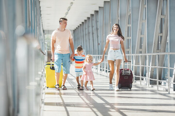 Happy family in airport departures. People in terminal preparing for the vacation