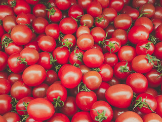 Group of fresh red cherry tomatoes at market