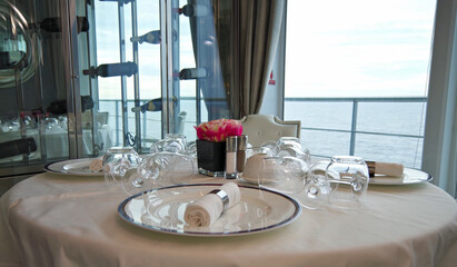 Elegant formal dining room or restaurant onboard luxury cruiseship or cruise ship liner in white...