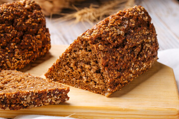 Closeup on sliced triangle flourless diet grain bread on wooden board