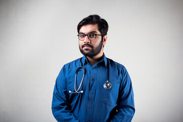 A doctor wearing stethoscope standing in front of a wall