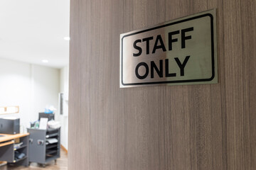 Warning sign in front of the door with a message for staff only with inside the sound control room.