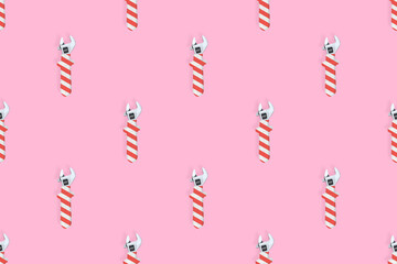 Adjustable wrench seamless pattern. Background made of a metal adjustable wrench with a rubber striped handle. 