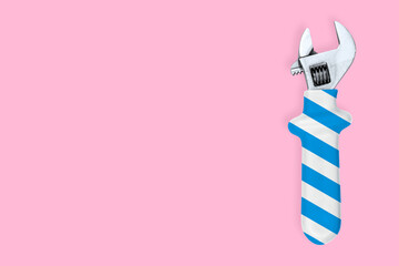 Adjustable metal wrench. Background made of a metal adjustable wrench with a rubber striped handle. 