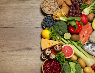 Different products on wooden table, top view with space for text. Healthy food and balanced diet