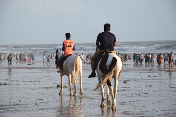 Lifeguard riding on beach 