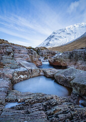 the waterfalls in glen etive near rannoch moor and glencoe valley in the argyll region of the highlands of scotland during winter