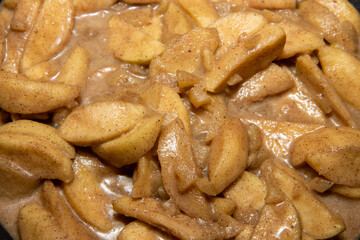 A pan full of sliced spiced cooking apples ready to be put in a delicious apple pie
