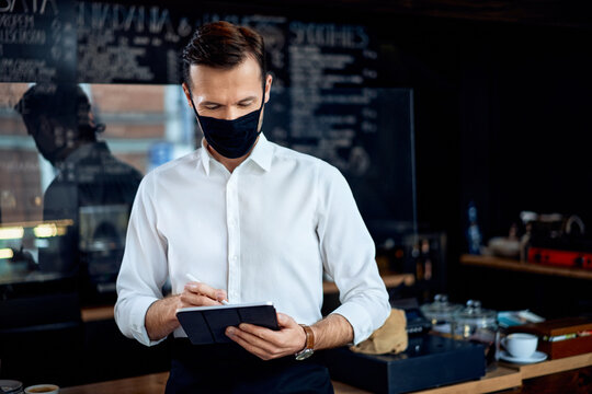 Portrait Of Restaurant Cafe Owner Using Digital Tablet