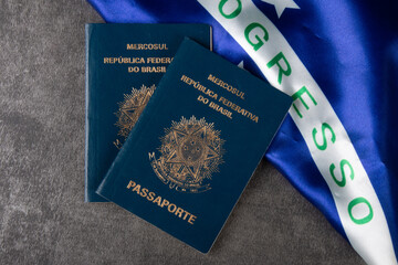 Brazilian passport with Brazilian flag in the background