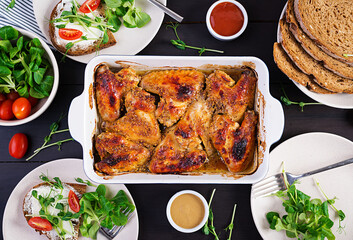 Grilled chicken wings. Baked chicken wings on wooden table. Table setting. Top view, flat lay, overhead
