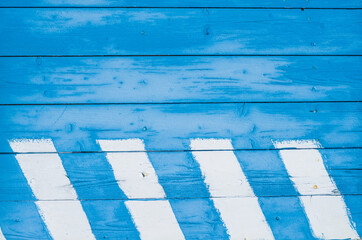 Wooden background with faded turquoise peeling paint. Old wooden painted texture surface.