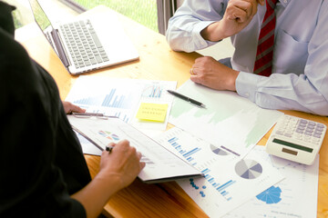 The businessperson is listening to the input from the team