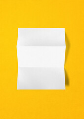 Blank folded White A4 paper sheet mockup template on yellow background