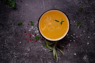 selective focus. Homemade Beef Bone Broth in a deep soup bowl. on a dark background. with the addition of spices-salt and pepper. Bones contain collagen, which provides the body with amino acids