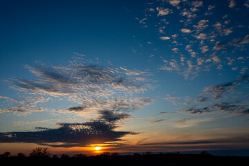 The setting sun nears the horizon in Ankeny, Iowa.