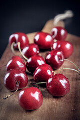 Fresh cherries on a wooden cutting board