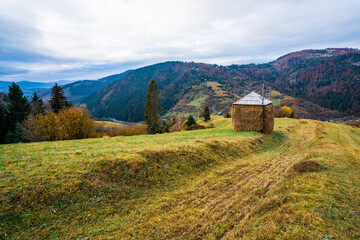 Haystack in a green meadow in not very good weather