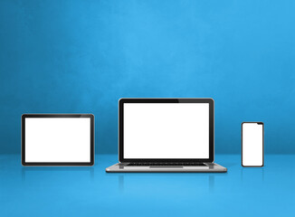 Laptop, mobile phone and digital tablet pc on blue office desk