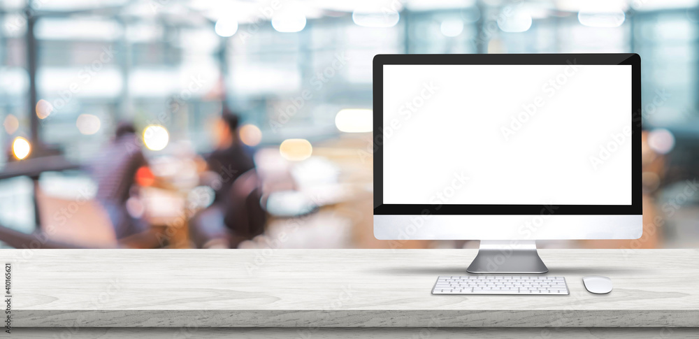 Poster Blank screen desktop computer on wooden table top with blur people working at creative office bokeh background,Mock up for display or montage of design