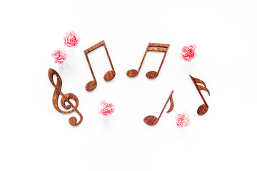 Flat lay of musical notes with flowers. Love songs concept