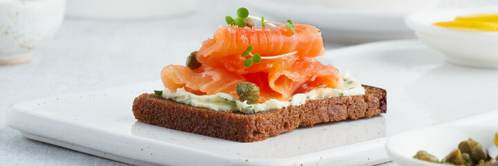 Smorrebrod - traditional Danish sandwiches. Long width banner for web sign. Black rye bread with...