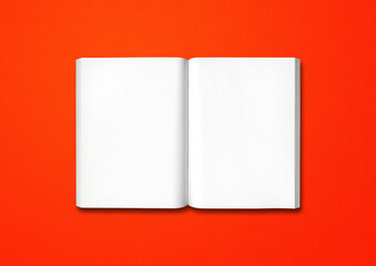 Open book isolated on red