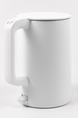 white electric kettle with lid lift button and switch on white background