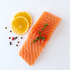 Fresh raw uncooked salmon fillet slice steak fish on white background with seasoning and lemon, top...