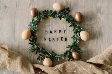 Easter eggs and and green wreath. Congratulatory easter background.