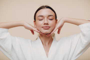 Young woman doing face building yoga facial gymnastics self massage and rejuvenating exercises - 410167040