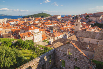 Fototapeta na wymiar A view into the old town of Dubrovnik, Croatia and Adriatic Sea looking down from atop the ancient city walls on a sunny, summer afternoon.