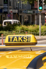 Izmir, Turkey. June 6, 2019: Roof of a yellow taxi and sign in the city.