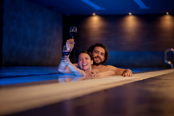 Couple relaxing in spa center swimming pool